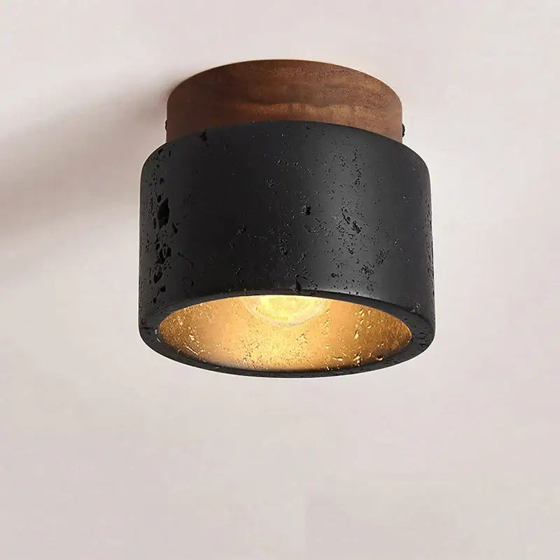 Rustic black travertine ceiling light featuring a textured concrete cylinder with brass interior and wooden top cap for hallway decorbites black travertine black travertine ceiling