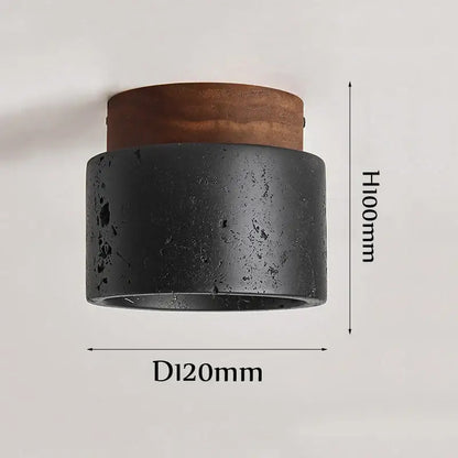 Rustic black travertine ceiling light featuring a black textured concrete wall sconce with a warm brown wooden top
