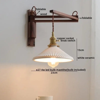 Rustic brass and clear glass wall sconce featuring a white ceramic pendant lamp with fluted design and braided cord mount