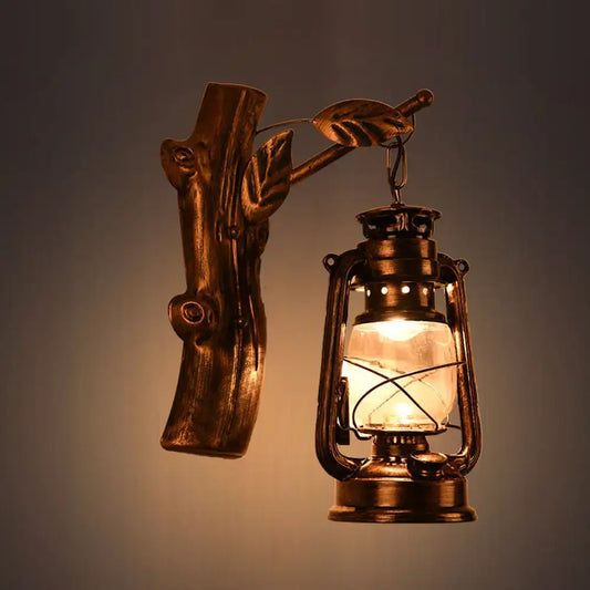 Antique brass-finished oil lantern wall sconce with rustic wooden branch design and clear glass for corridor lighting