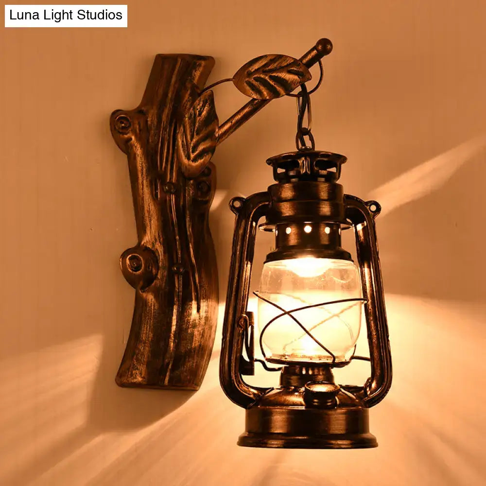Antique-style rustic black oil lantern wall sconce with clear glass globe and leaf-accented wooden bracket for corridor lighting