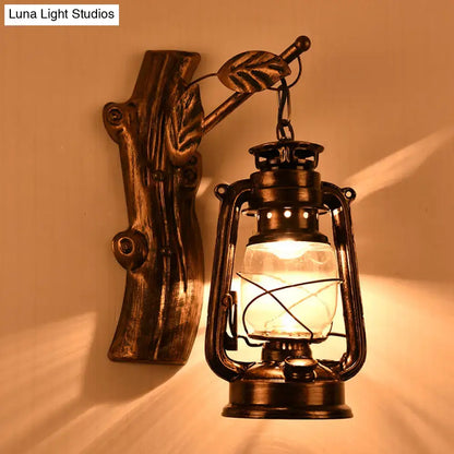 Antique-style rustic black oil lantern wall sconce with clear glass globe and leaf-accented wooden bracket for corridor lighting