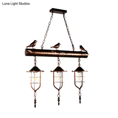 Bronze finished decorbites coastal style metal caged island pendant light with three lanterns and birds on wooden beam
