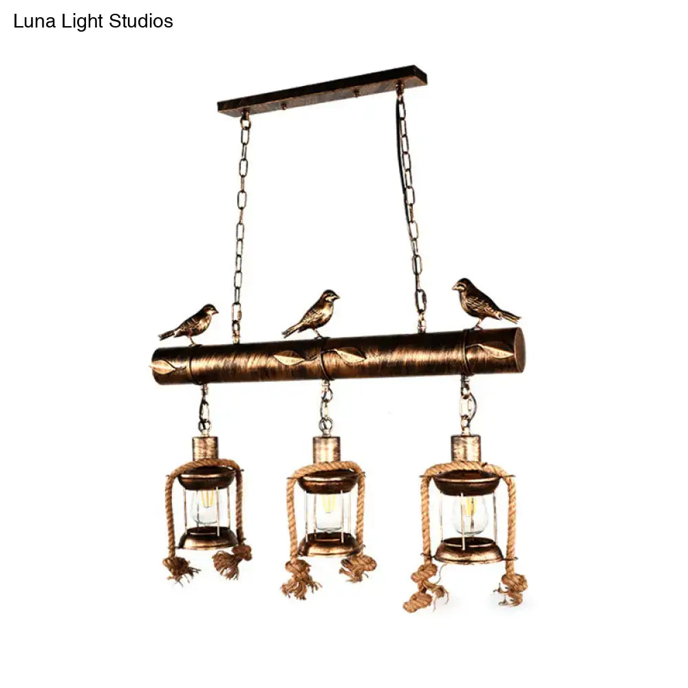 Decorbites™ coastal style metal caged island pendant light in bronze with three lanterns rope detailing and bird figurines