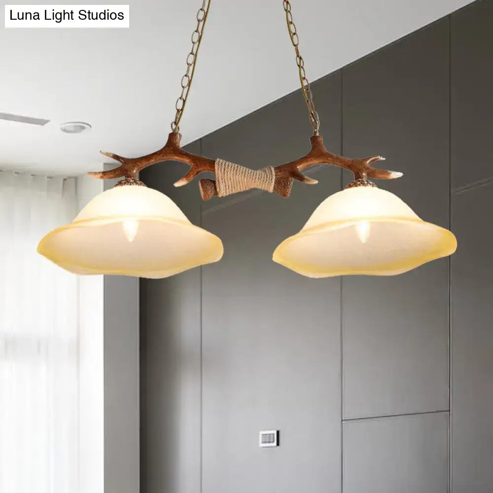 Decorbites™ 2-light traditional bell glass island pendant in brown with antler-themed wooden frame and warm shade shape