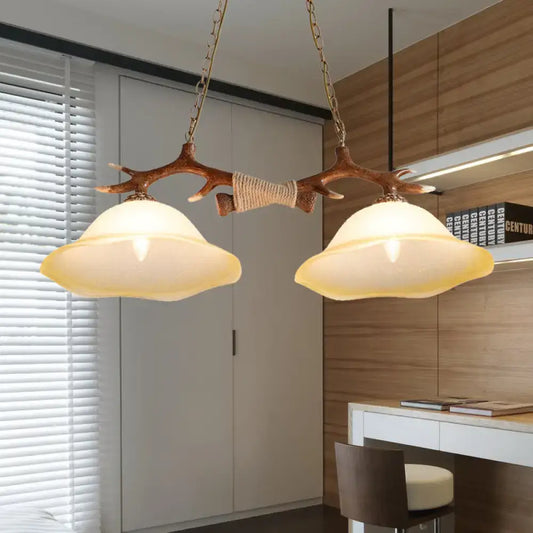 Decorbites 2-light traditional bell glass island pendant in brown with antler-themed wooden branch and warm incandescent shades
