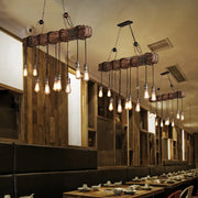 Decorbites 10-head metal pendant light fixture with exposed bulbs and rustic wooden beam in brown finish