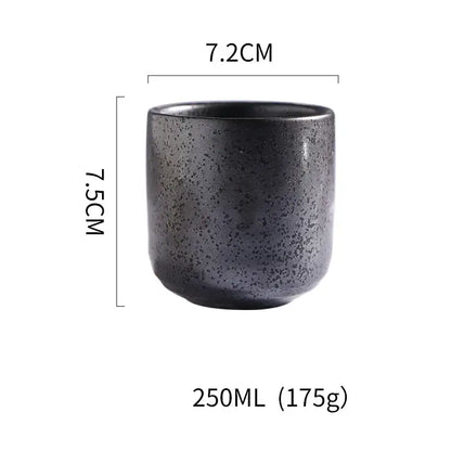 A dark gray speckled matte coarse ceramic tea cup with a tapered shape from decorbites coarse ceramic set