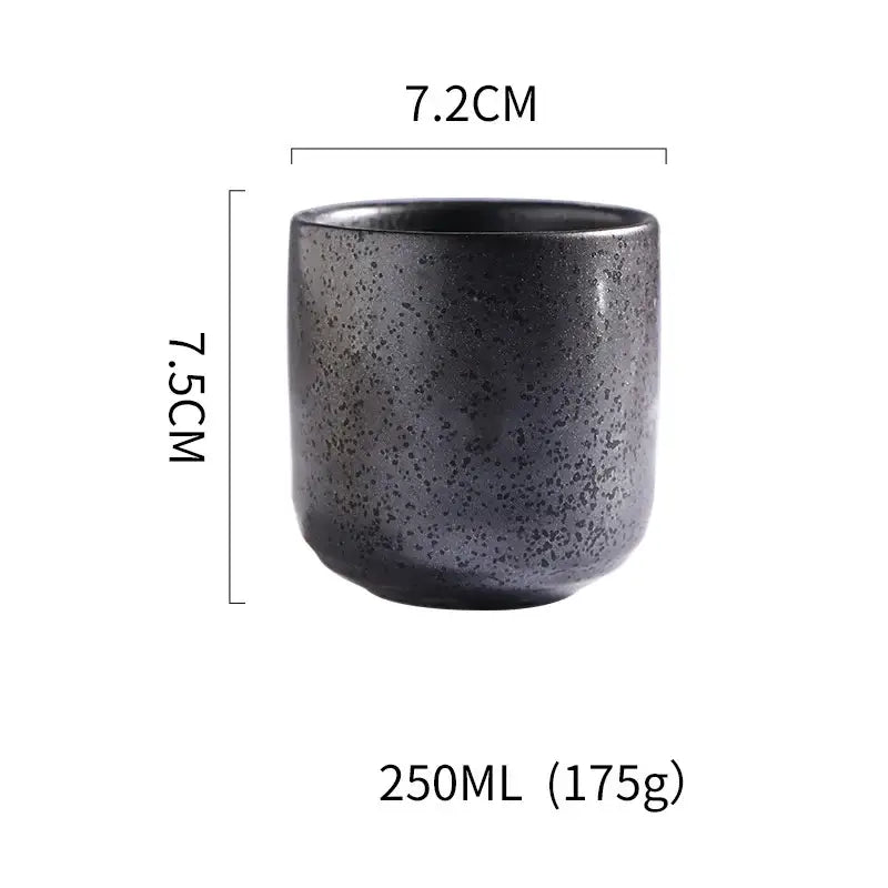 A dark gray speckled matte coarse ceramic tea cup with a tapered shape from decorbites coarse ceramic set