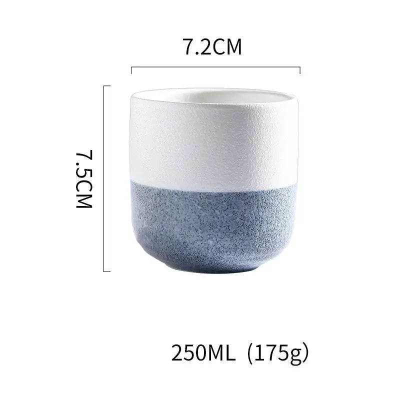 A rustic coarse ceramic tea cup with a two-tone smooth white and speckled blue design perfect for decorbites coarse ceramic sets