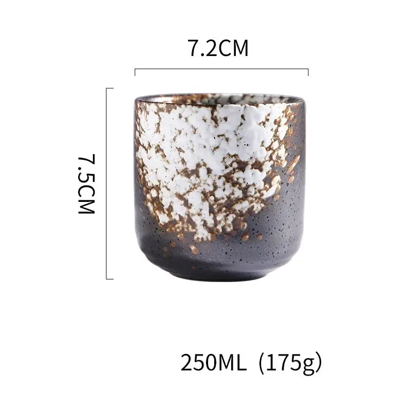 Rustic coarse ceramic tea cup with speckled black white glaze and golden flecks hand painted for dining room decorbites