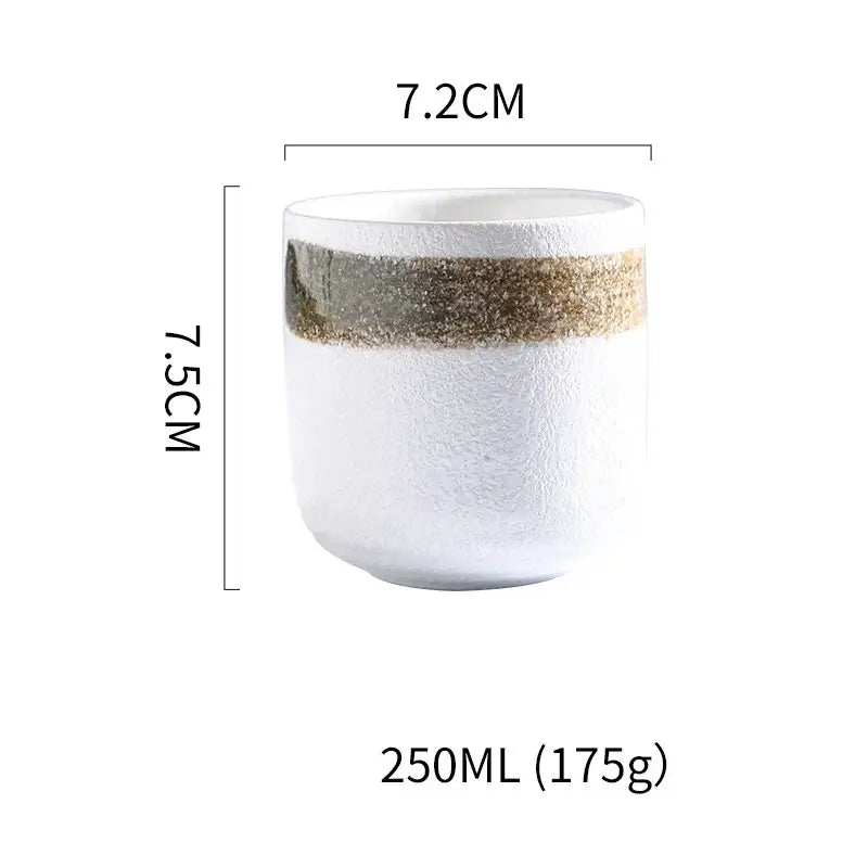Rustic coarse ceramic tea cup with textured white surface and gold gray speckled band ideal for decorbites coarse ceramic set