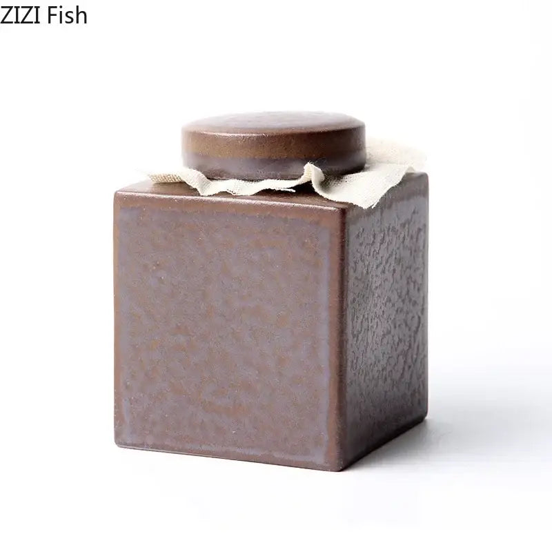 Rustic earth toned brown ceramic tea canister with matching lid and light fabric lining for kitchen storage jar