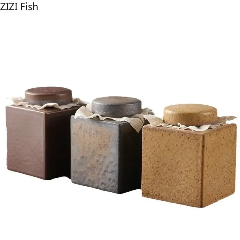 Rustic earth toned ceramic tea canister set with textured surface and fabric band for kitchen storage jars