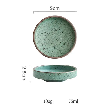 A ceramic round sauce dish with speckled teal glaze and brown rim from the decorbites ceramic round set