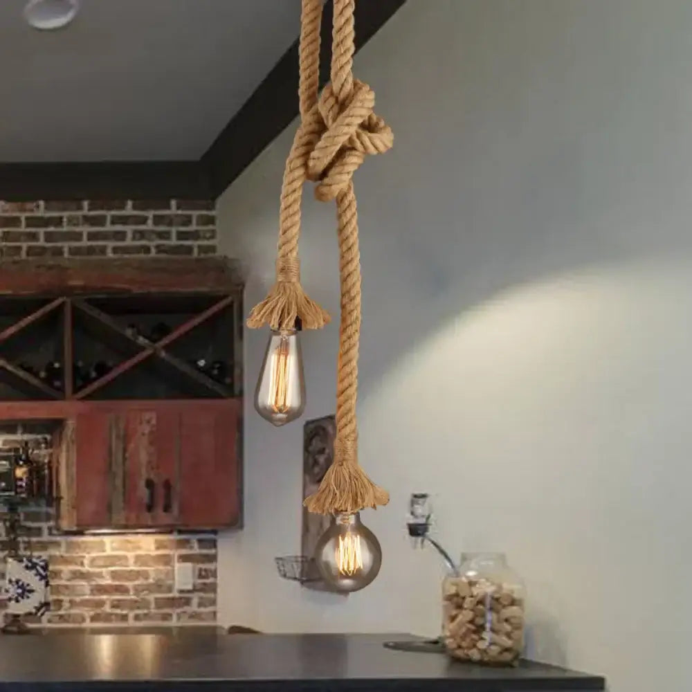 Rustic hemp rope pendant light with two exposed filament bulbs for decorative lighting in the dining room