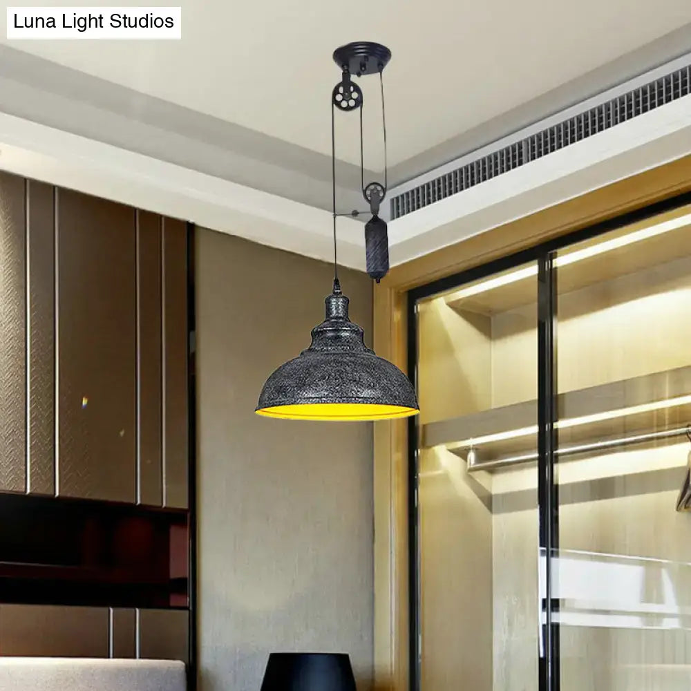 Black metal rustic industrial dome pendant lamp with intricate etched patterns and warm yellow interior for living room lighting