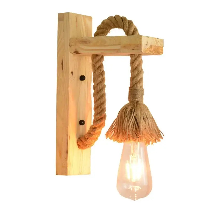Rustic industrial hemp rope wall lamp featuring a wooden sconce with thick natural rope tassel and exposed edison bulb