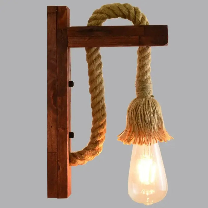 Rustic industrial wall lamp with beige hemp rope and frayed tassel featuring exposed Edison bulb decorbites hemp rope design