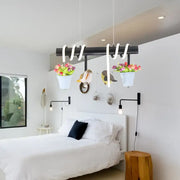 Black metal spiral rustic led island pendant light with white hanging flower pots and bird decorations by DecorBites