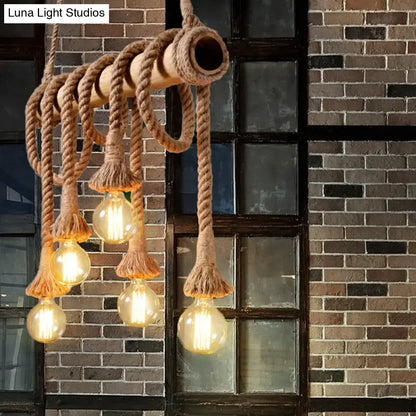 Rustic industrial island light with adjustable beige rope and bamboo structure featuring exposed filament bulbs