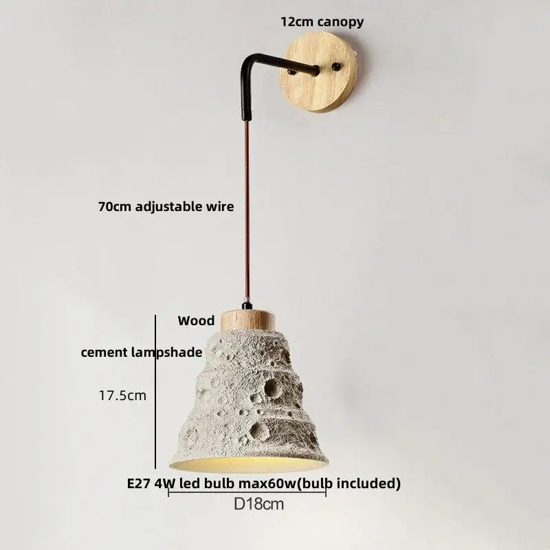 Rustic moon cement led wall lamp with textured gray concrete lampshade hanging from wood base by adjustable wire
