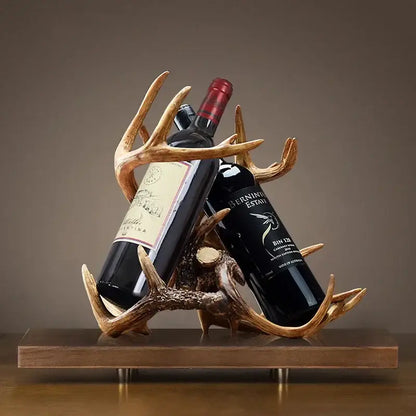 Rustic natural resin buckhorn wine holder with antler design in natural finish holding two dark glass bottles for decorbites wine holder