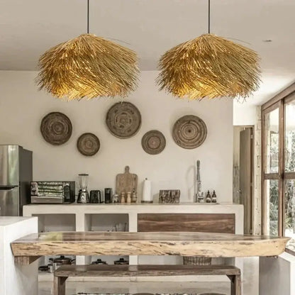 Two golden pendant lights with natural straw shade hang from ceiling to bring warmth to dining rooms