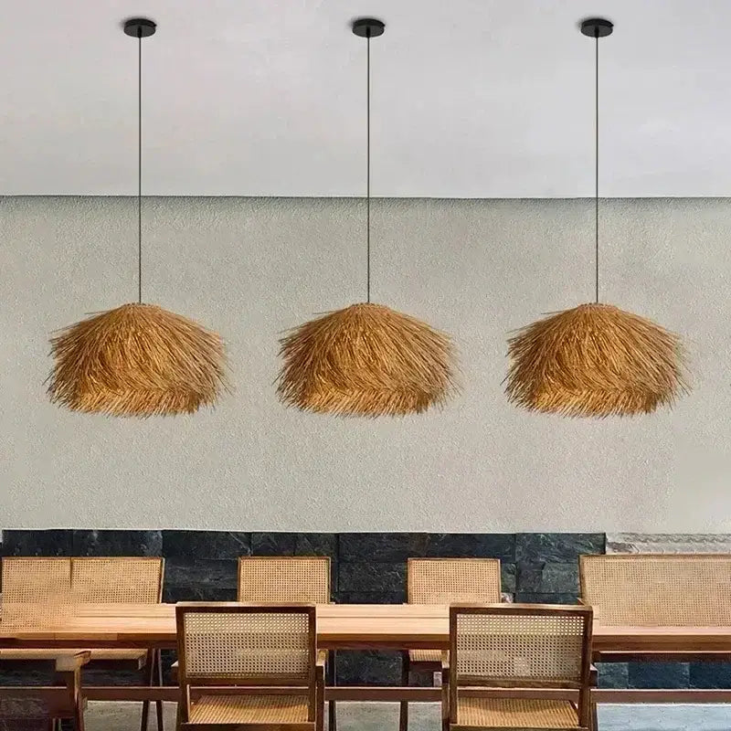 Three hanging pendant lights with natural straw shade and golden-brown thatched design to bring warmth to dining rooms