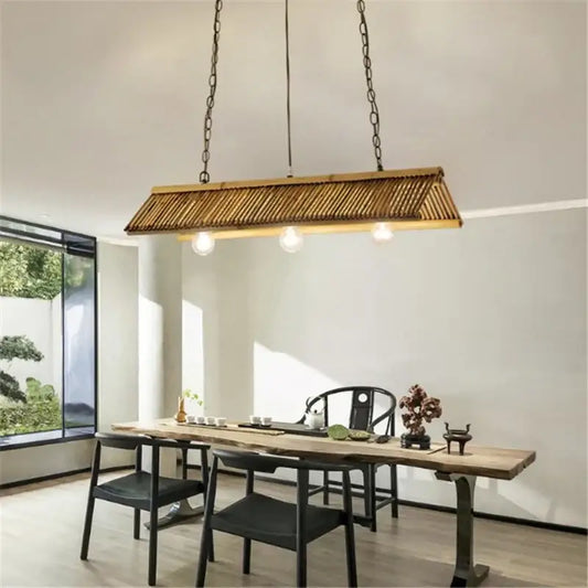 Rustic slatted wood bamboo pendant chandelier with three exposed bulbs suspended by dark metal chains for kitchen lighting decorbites bamboo pendant