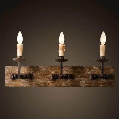 Rustic wrought iron wall light with three candle bulbs mounted on solid wood plank for decorbites country retro decor