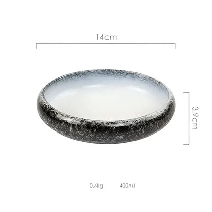 A sleek 14cm wide rustic speckled white and black ceramic kimchi plate with a black and white glaze finish