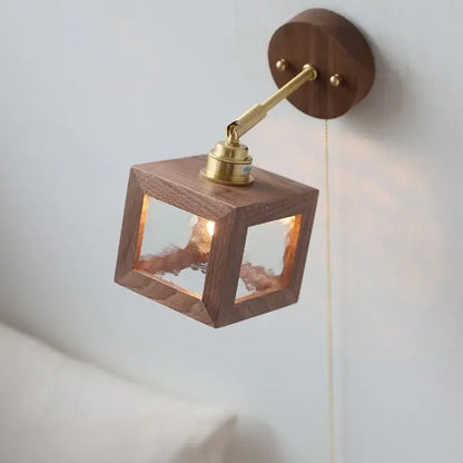 Rustic walnut and brass glass wall light fixture with warm wood cube and frosted panels for bedroom sconce