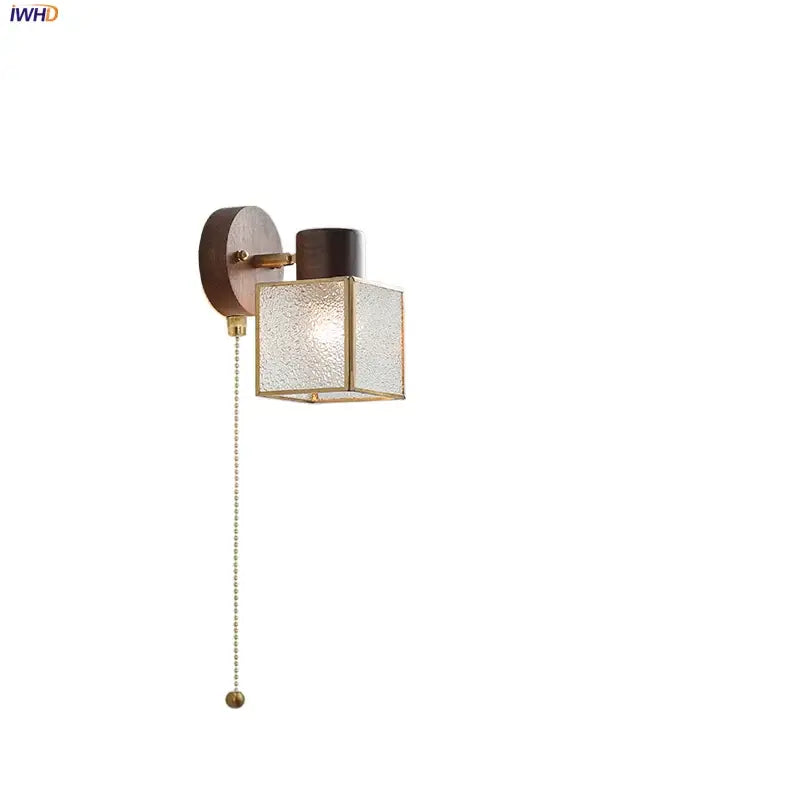 Rustic walnut and brass led wall lamp with a dark wood backplate and textured glass cube shade for bedroom use