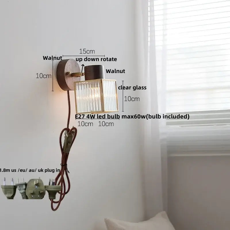 Rustic walnut wood and brass wall sconce with clear glass shade featuring vertical ridges and adjustable rotation