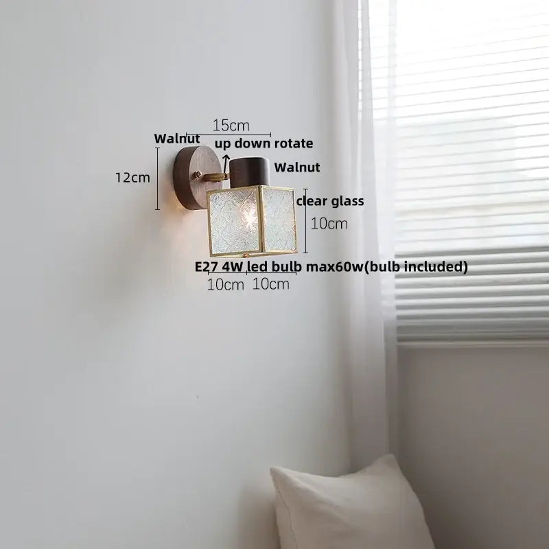 Rustic walnut wood and brass wall sconce with dark walnut metal arm and clear glass panels etched with floral pattern