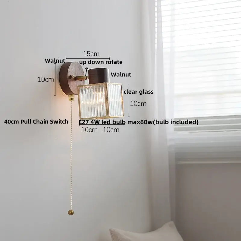 Rustic walnut wood wall sconce with clear glass ribbed shade and brass accents for bedroom lighting fixture