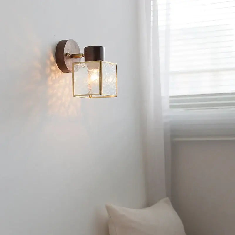 Rustic walnut wood and brass wall sconce with clear glass square shade on dark wood backplate for bedroom use