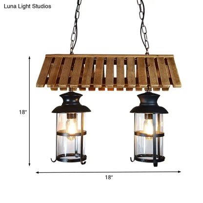 Rustic wood and black antique cylinder island lamp with wooden slats and clear glass panels for kitchen lighting