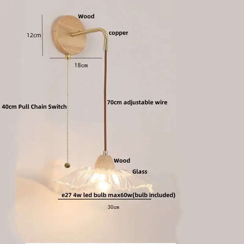 Rustic wood and brass wall light with natural wood base, clear glass lampshade, and pull chain switch with copper accents