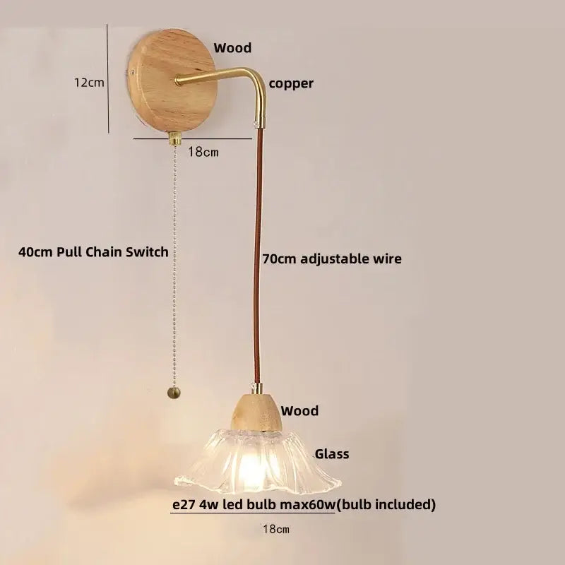 Rustic wood and brass wall light with clear glass bell shade and pull chain switch mounted on circular wooden backplate