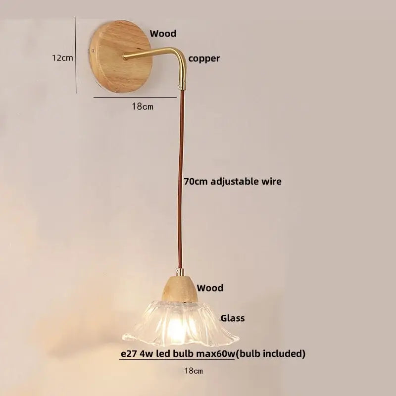 Rustic wood and brass wall light with clear glass bell shade and pull chain switch on natural wood circular backplate