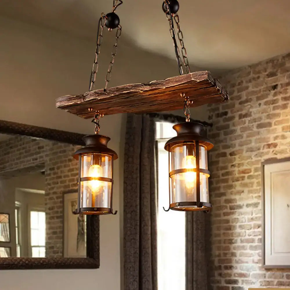 Rustic brown wooden plank pendant light with two clear glass lantern-style fixtures for clear glass island use