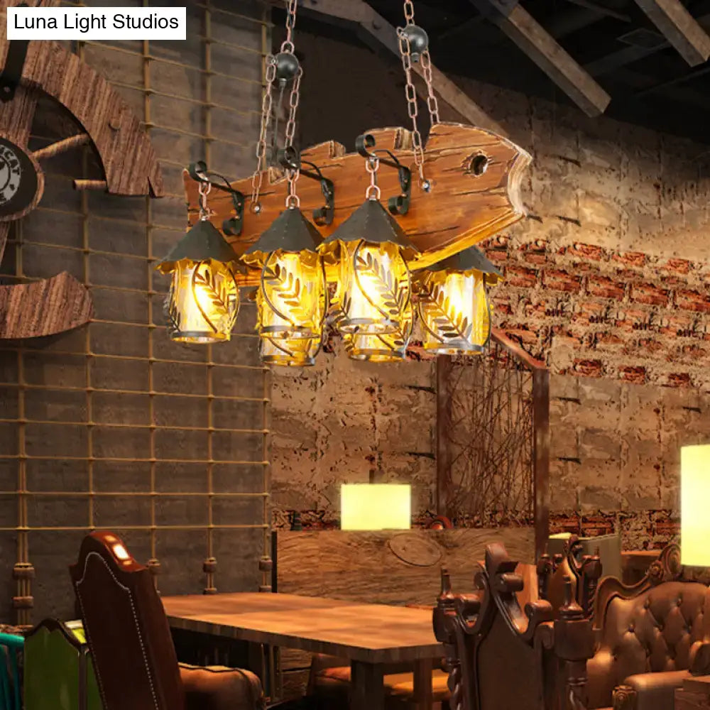 Rustic wood and glass dining room chandelier with four amber glass lanterns and black metal arm island lamp design