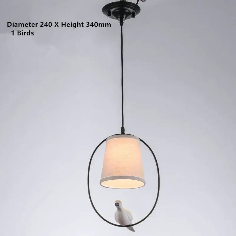 Black metal decorbites bird lamp with beige fabric shade and white bird figurine for rustic dining room chandelier