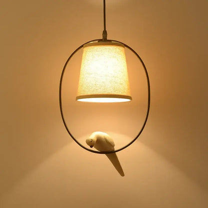 Rustic wood and iron decorbites bird lamp with beige fabric shade and white ceramic parrot for dining room lighting