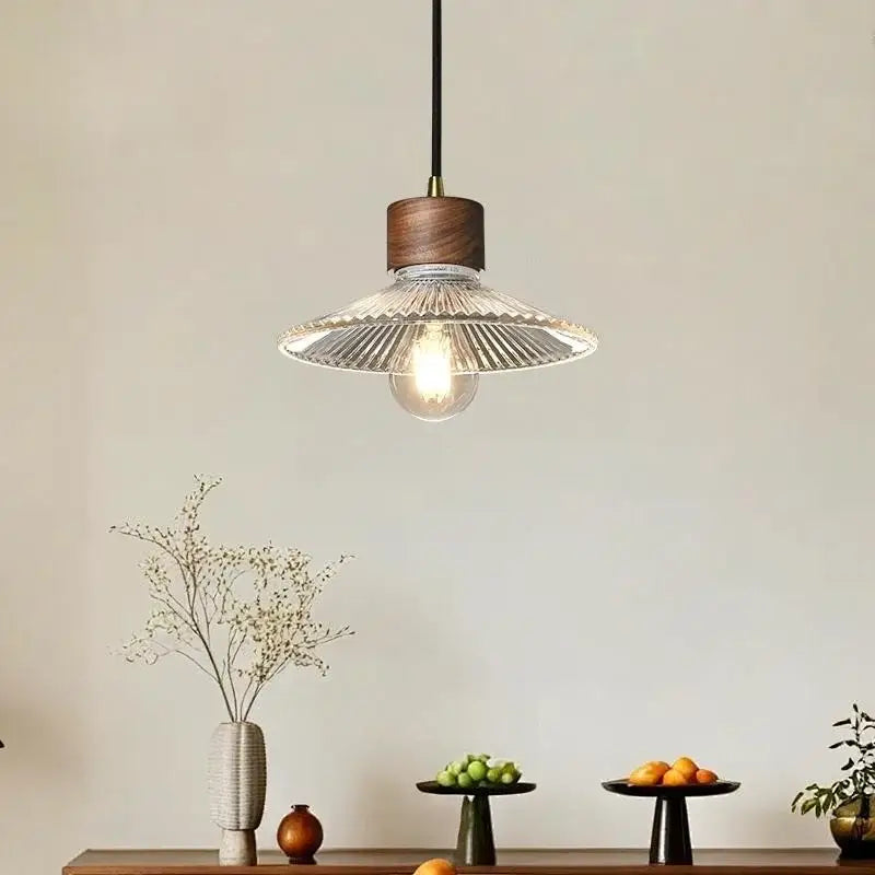 Rustic wood and ribbed glass led pendant light with warm tones and dark wood top for dining room use