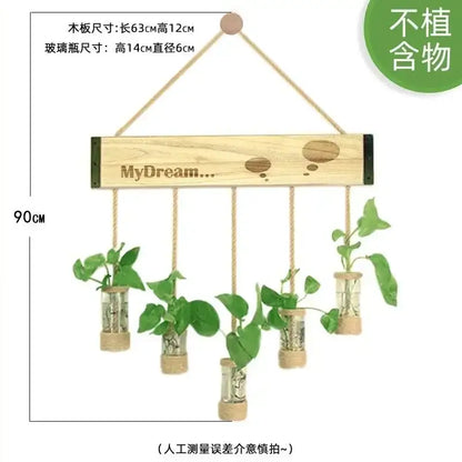 Light-colored wooden stand with five glass planter vases hanging by ropes containing small green plants for wall decor