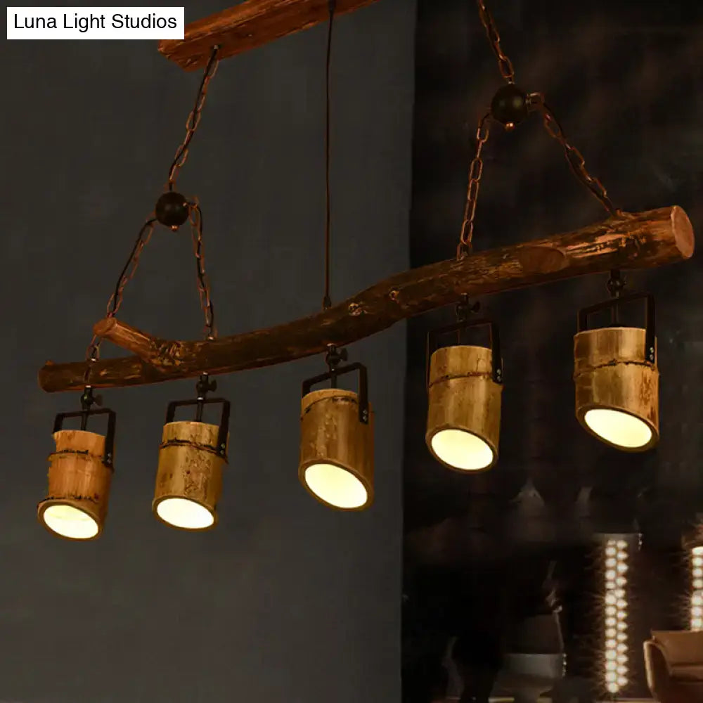 Rustic wood linear island pendant light with four brass cylindrical spotlights for dining room lighting