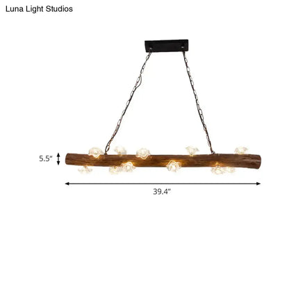 Rustic wood log hanging lamp with clear glass globe bulbs and black metal chains for kitchen chandelier lighting